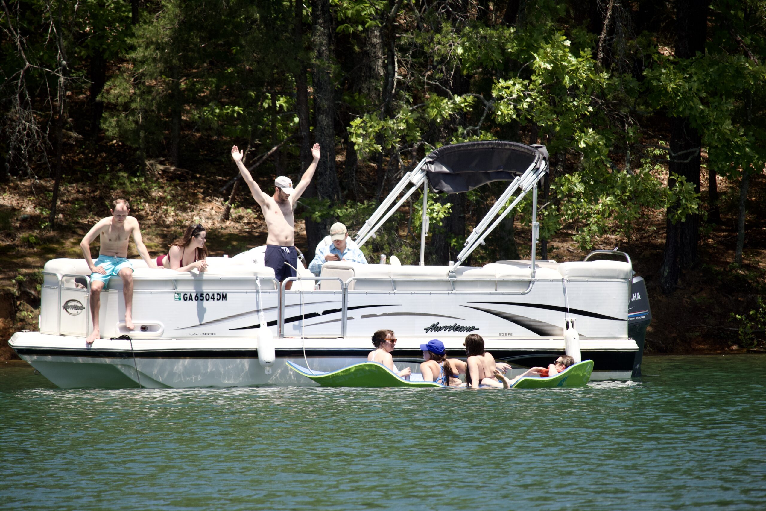 People With A Hurricane Deck boat & Lily pad on Lake Blue Ridge